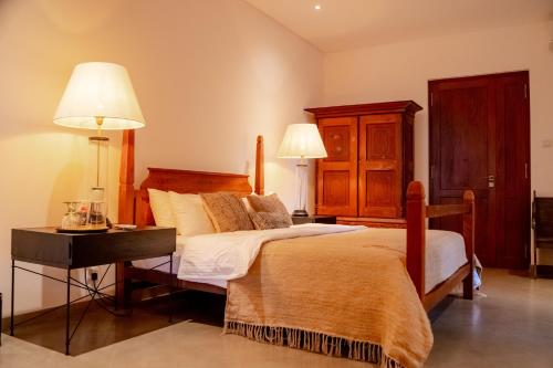 a bedroom with two beds and a table and two lamps at Lily Pod in Panadura