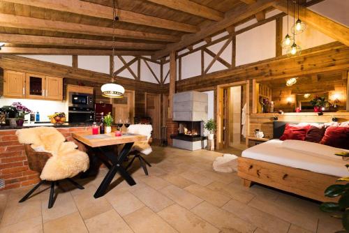 a large living room with a table and a couch at Bayerischer Wald Chalets in Zwiesel