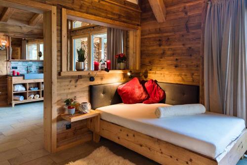 a bedroom with a bed in a wooden room at Bayerischer Wald Chalets in Zwiesel