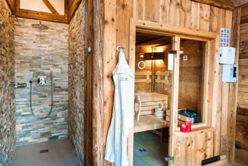 a bathroom with a shower and a glass door at Bayerischer Wald Chalets in Zwiesel
