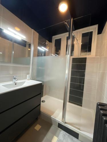 a bathroom with a shower and a sink and a tub at AppArt Residence Georges Sand BD Films Remparts Angouleme Gare TGV in Angoulême