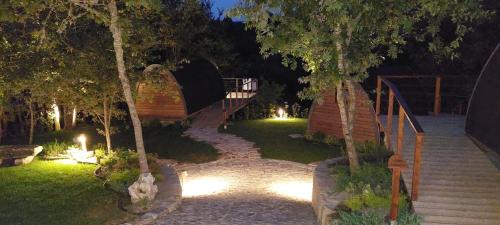 a house with a staircase in a garden at night at Green Paradise Glamping in Covas