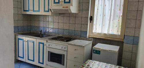 a small kitchen with a stove and a sink at Hotel Selenia Residence in Castro di Lecce
