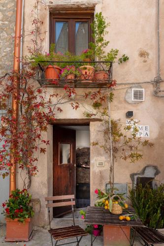a building with a balcony with potted plants on it at WUNDERGARTEN Private Home Spa in Gratteri