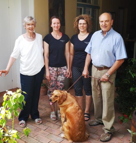 a group of people posing with a dog on a leash at Stieglerhof KG in Illmitz