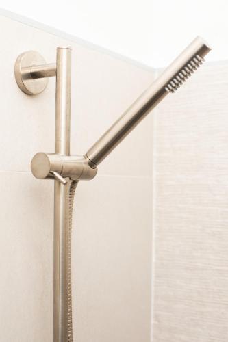 a shower head is attached to a wall at Appartamento centro storico Gubbio in Gubbio