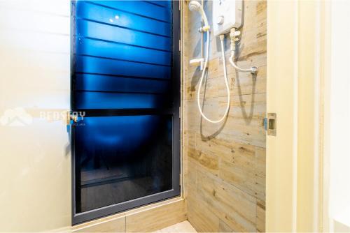 a shower with a blue shower curtain in a bathroom at Arte Mont Kiara Serviced Suites by Bedstay.MY in Kuala Lumpur
