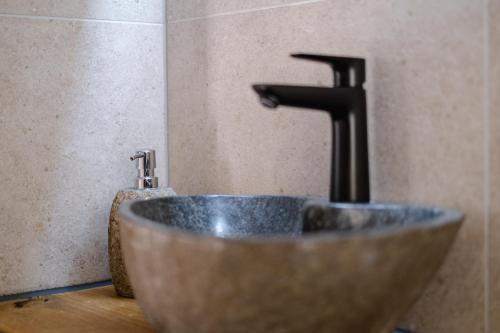 a sink with a faucet in a bathroom at Alex & Rine - Pension Zum Alten Strom in Warnemünde