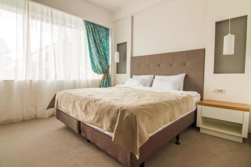 Una cama o camas en una habitación de Gardenia Hotel & Spa