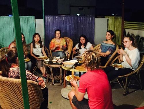a group of people sitting around a table at Chalo Eco Hostel in Jaipur