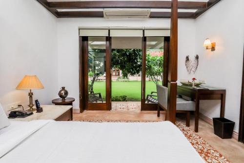 um quarto com uma cama e uma secretária. em Saptapuri by Royal Orchid Hotels Limited Varanasi em Varanasi