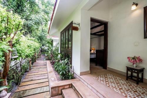 an entry way to a house with plants at Saptapuri by Royal Orchid Hotels Limited Varanasi in Varanasi