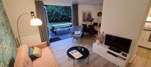 a living room with a couch and a television at Bij Ons Naast in Nuenen