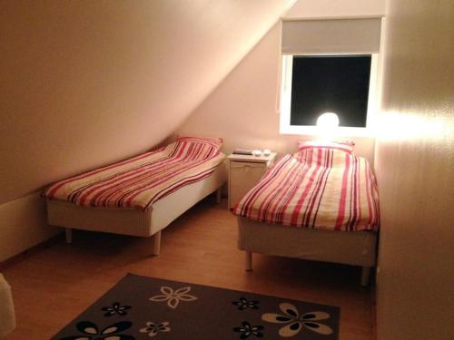 2 camas en una habitación pequeña con ventana en Relaxhouse, 