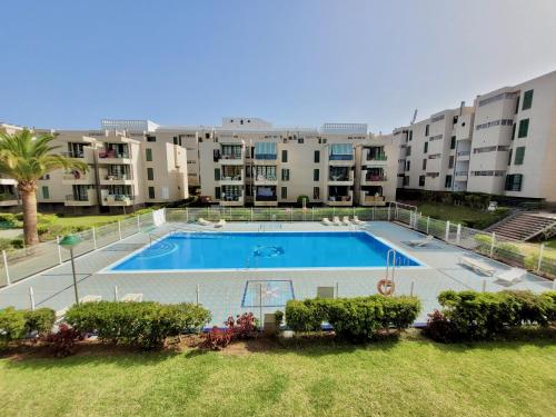 an image of a swimming pool in a apartment complex at Las Americas Beach House in Arona