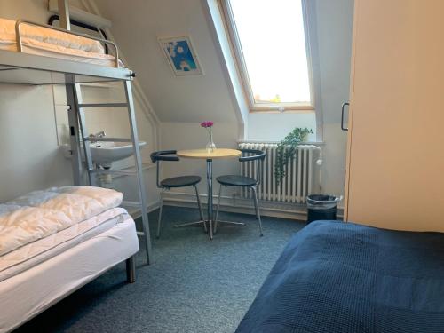 a small room with a bed and a desk at Danhostel Odense Kragsbjerggaard in Odense