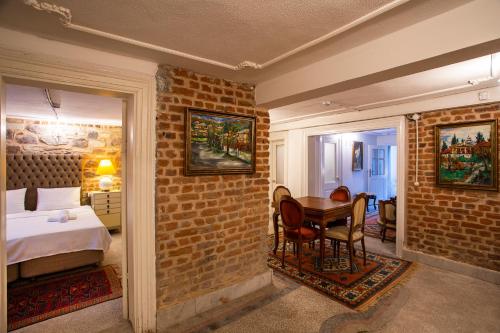 a bedroom with a bed and a table in a room at Mansion with Lemon Tree in Izmir