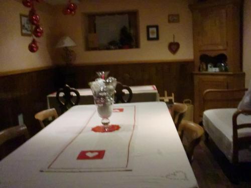 a dining room table with a vase on top of it at Chambres d'hôtes chez Loulou et Caramel in Magstatt-le-Bas