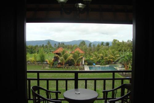a view from a window of a resort with a pool at Atres Villa in Munduk