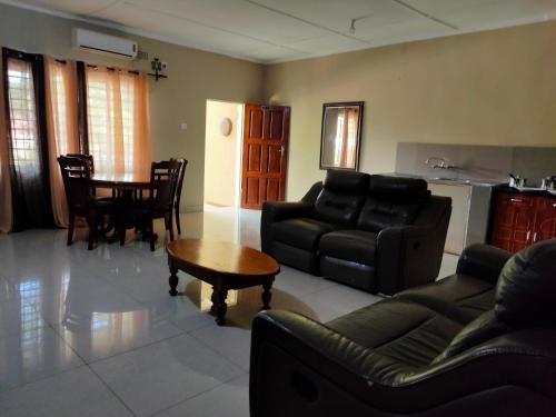 a living room with a couch and a table at Golden Days Lodge in Livingstone