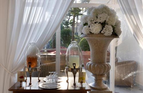 a table with two vases and a vase with flowers at Hotel Continental in Sorrento
