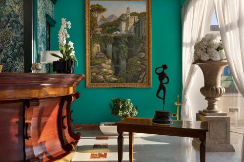 a room with a painting on the wall and a table at Hotel Continental in Sorrento