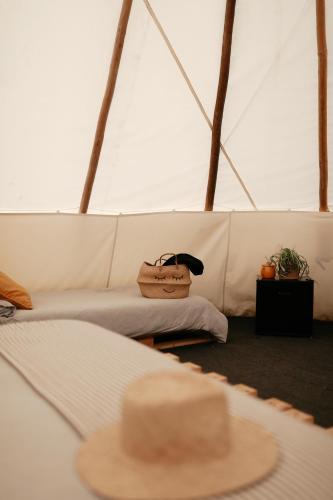 a white couch with a purse on a table at White House on Wye Glamping in Brockhampton