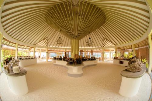 a large room with a large ceiling with chandeliers at Hondaafushi Island Resort in Vaikaradhoo