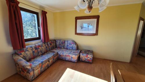 a living room with a couch and a window at Appartement zur Post in Ferlach