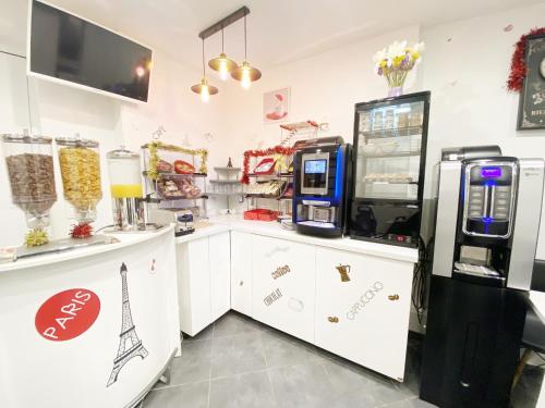 a grocery store with a cash register and a popcorn machine at Hotel Aviatic in Paris
