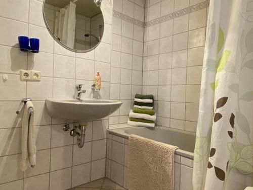 bagno con lavandino, vasca e specchio di Ferienhof Weber Nieratz a Wangen im Allgäu