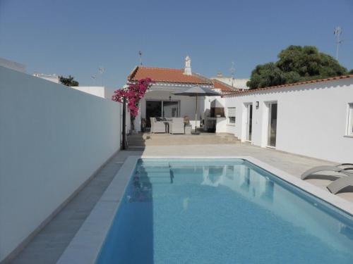 a swimming pool in the backyard of a house at CASA DOS AVOS in Cabanas de Tavira
