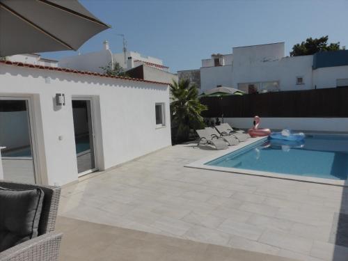 a swimming pool in the backyard of a house at CASA DOS AVOS in Cabanas de Tavira