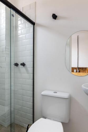 a white bathroom with a toilet and a shower at ZEST Teodoro in Sao Paulo
