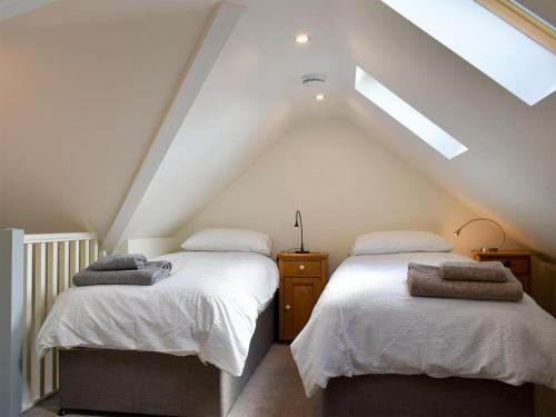 two beds in a attic room with a roof at Belfield in Canon Frome
