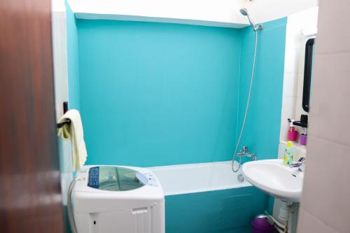 a blue bathroom with a toilet and a sink at Mdiq Chalet in M'diq
