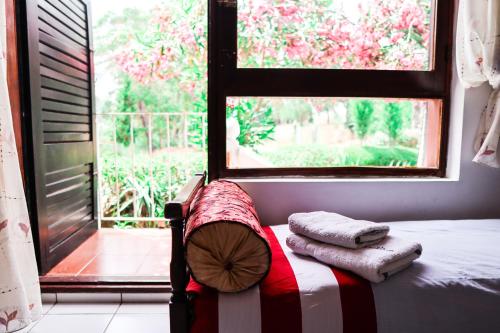 a bed in a room with a window and towels at Mdiq Chalet in M'diq