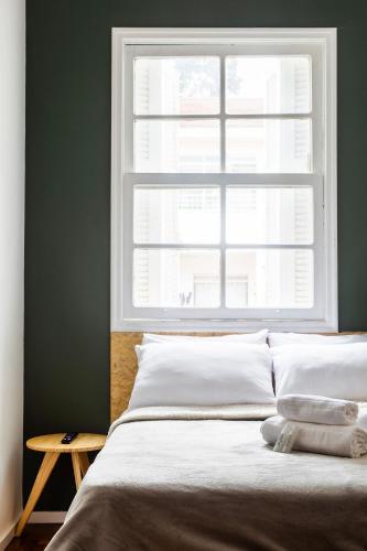 a bedroom with a bed with a window above it at ZEST Teodoro in Sao Paulo