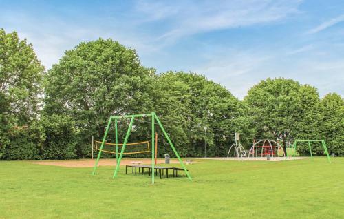 an empty park with two swings and a playground at Vijverzicht 218 met whirlpool in Gramsbergen