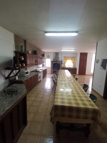 a large kitchen with a long table in a room at CASA rural DOLORES en Adeje in Adeje