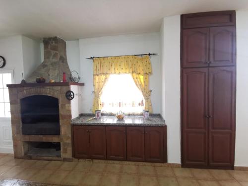 a living room with a fireplace and a window at CASA rural DOLORES en Adeje in Adeje