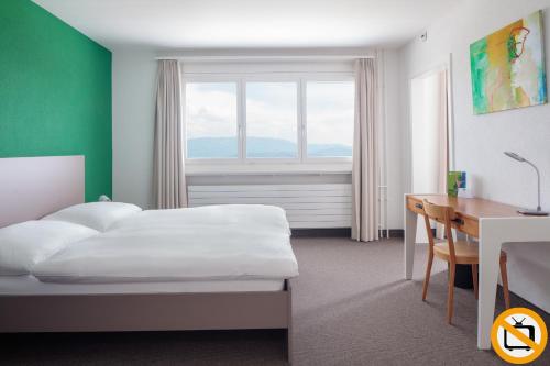 Postel nebo postele na pokoji v ubytování Le Domaine (Swiss Lodge)