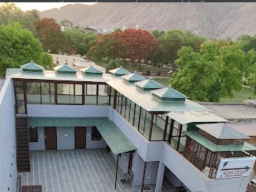 a building with a swimming pool on top of it at Sukh Sagar Hotel in Jaipur