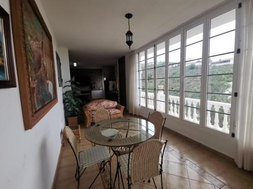 a living room with a glass table and chairs at CASA rural DOLORES en Adeje in Adeje