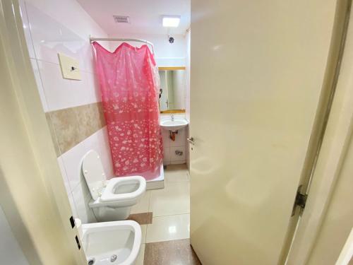 a small bathroom with a toilet and a sink at Roosevelt in Buenos Aires