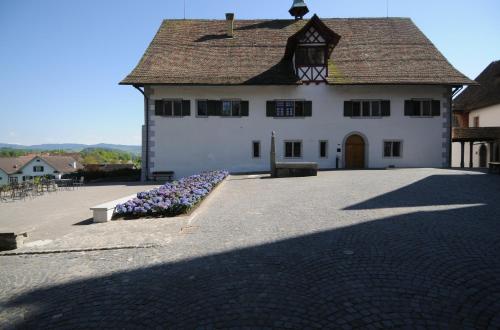 a large white building with purple flowers in front of it at Kloster Kappel in Kappel am Albis