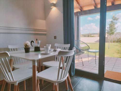 a dining room with a table and chairs and a window at Apartamentos Walden by gaiarooms in Morille