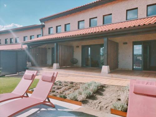 a group of chairs sitting in front of a building at Apartamentos Walden by gaiarooms in Morille