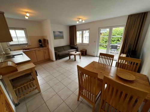 a kitchen and living room with a table and chairs at Chico in Graal-Müritz