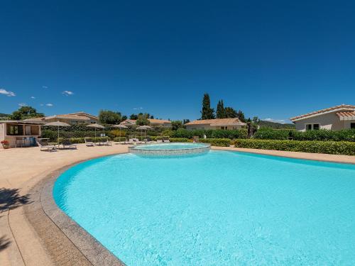 a large blue swimming pool with a fountain at Ville D'Ogliastra in Cardedu